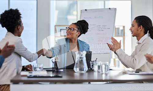 Image of Handshake, success or applause of business people in a meeting or presentation for sales goals or deal. Partnership, b2b collaboration or happy black woman shaking hands with a manager in leadership
