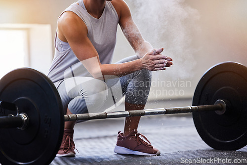 Image of Hands, bodybuilding and powder with a woman weight lifter getting ready to exercise or workout at gym. Fitness, grip and training with a female bodybuilder weightlifting for strong muscles or health