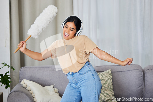 Image of Music, dance and cleaning with a woman housekeeper in a home alone for hygiene while having fun. Radio, dancing and housekeeping with a female cleaner streaming or listening to audio in a living room