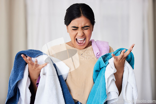 Image of Laundry, frustrated and woman with anger, screaming and overworked with spring cleaning, chores and hygiene. Female, cleaner and maid angry, upset and washing material with burnout or fatigue in home