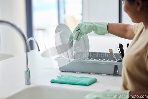 Image of Woman, hand and dishes in kitchen by sink for washing, packing or hygiene in house with gloves. Cleaner lady, hands or home for dry plate, stop bacteria or cleaning service for health in apartment