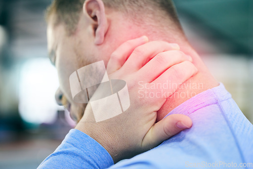 Image of Fitness, gym and man with pain in neck, medical emergency during gymnastics workout at sport studio. Exercise, health and wellness, person with hand on red muscle cramps ache or injury while training