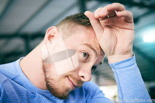 Image of Exercise, sweat and tired man at gym for training, cardio or intense workout on blurred background. Fitness, break and sweating athletic male stop to breath during exercising routine at sports center