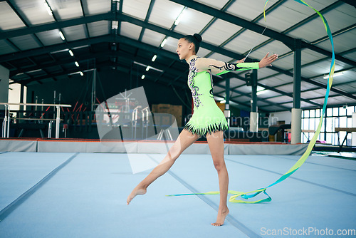 Image of Rhythmic gymnastics, fitness and woman in gym with ribbon, sport and graceful athlete on mat. Dance, girl gymnast and flexibility with pose and sports, mockup space with training or performance