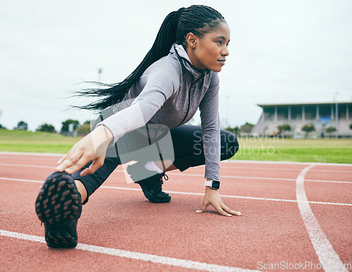 Image of Fitness, exercise and black woman stretching legs for health and wellness at stadium outdoors. Winter sports, training runner and female prepare and get ready to start workout, running or exercising.