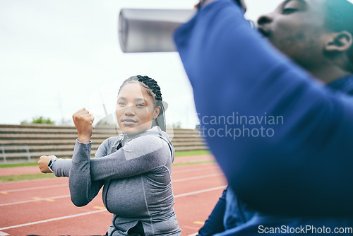Image of Running, sports and black woman stretching on race track for exercise, marathon training and fitness. Stadium, workout and athlete team warm up, drink water and ready for challenge, run and racing