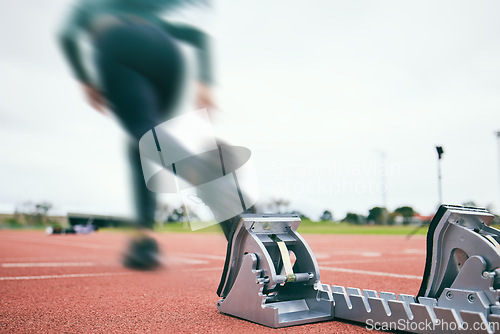 Image of Motion blur, running and race start blocks with athlete on stadium, person and speed, action and fitness outdoor. Training, runner sneakers and sports with exercise and cardio on track