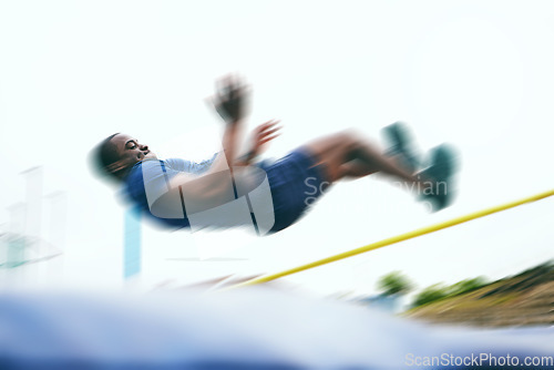 Image of Athletics, fitness and high jump by man at a stadium for training, energy and cardio with blur and speed. Jumping, athlete and male outdoors for performance, endurance and competition on mock up