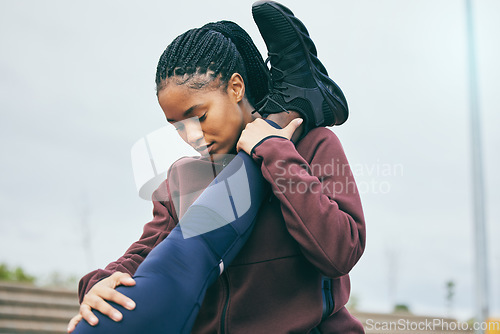 Image of Fitness, black woman and coach stretching legs for running exercise, workout or preparation at stadium. African American female mentor helping partner in warm up leg stretch for cardio or athletics