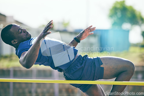 Image of Man, high jump and fitness or athletics at a stadium for training, energy and cardio against sky background. Jumping, athlete and male outdoors for performance, endurance and competition on mock up