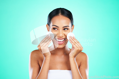 Image of Beauty, happy and woman with cotton for skincare isolated on a green background. Smile, routine and cosmetics model smiling with promotion of facial pads to clean face of makeup, product and dirt