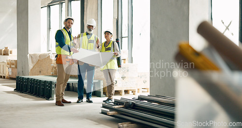 Image of Building, construction and architect with a team working on site while reading a blueprint or plans indoors. Teamwork, engineer and architecture with a man and woman contractor group in collaboration