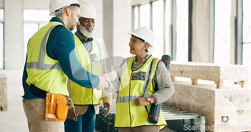 Image of Handshake, architecture and engineering team shaking hands with a project development designer in a building. Global, b2b and happy construction workers in meeting or partnership deal with contractor