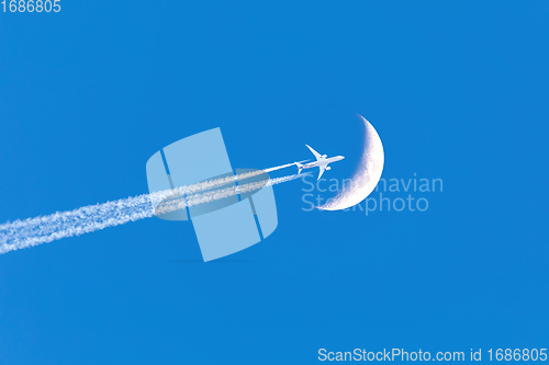 Image of Passenger plane passes near the moon