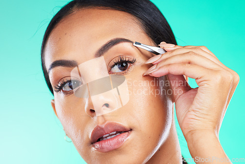 Image of Eyebrow tweezers, beauty and woman in studio for skincare wellness, aesthetic cleaning and facial. Female model, brows and hair removal for face cosmetics, growth maintenance and body epilation tools