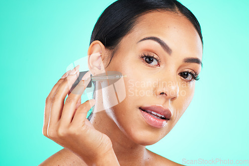 Image of Skincare, oil and portrait of woman in studio for beauty, wellness or cosmetic on blue background. Face, serum and girl for facial product for skin, anti aging or collagen, retinol or hyaluronic acid