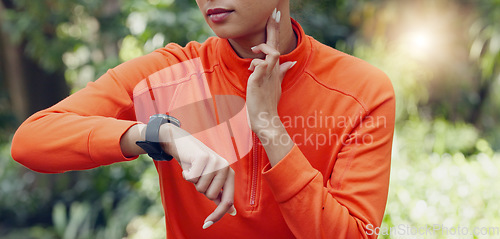 Image of Fitness, wellness and sport woman heart rate with smartwatch while training, exercise and workout in park and nature. Health, runner and healthy sports girl with watch for time to monitor performance