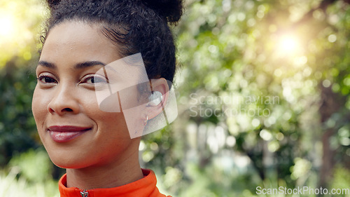 Image of Brazilian woman, earphones and music in fitness workout, forest background training and nature park exercise. Face zoom, happy smile or runner with wellness sports goals, motivation and radio podcast