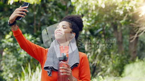 Image of Wellness, health and selfie by social media influencer advertising exercise, water and hydration. Fitness blogger recording content of weight loss journey while exercising in a park or forest