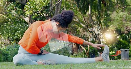 Image of Black woman stretching leg in the park for fitness, health and wellness before a run. Exercise, sports and female athlete warm up training outside or in nature for mobility, flexibility and strength.