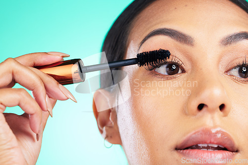 Image of Woman, face closeup and beauty with mascara for lashes, makeup tools and cosmetic product with microblading Cosmetics, skin and brush in hand for eyelash extension, self care on studio background