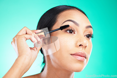 Image of Woman, face and beauty with mascara in hand for lashes, makeup and cosmetic product closeup with microblading. Cosmetics, skin and brush for eyelash extension, self care on studio background