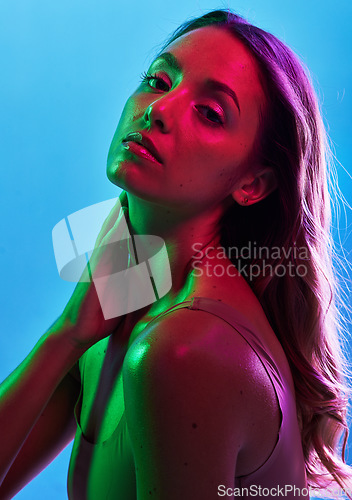 Image of Glowing skincare, portrait or neon lighting on isolated blue background and hands on neck, body or skin. Beauty model, woman or touching in creative fantasy green, pink or lights aesthetic in makeup