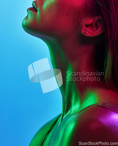 Image of Woman neck, skincare or neon lighting on isolated blue background in trendy, cool or stylish fantasy art in studio. Zoom, beauty or model body glow in creative aesthetic, green or pink lights texture