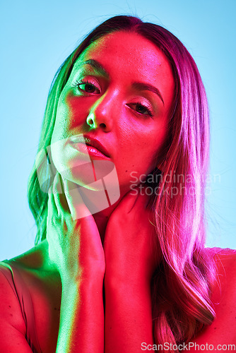 Image of Woman skincare, portrait or neon lighting on isolated blue background for trendy studio fashion or cool style. Beauty model, face or creative aesthetic art and green, pink lights or makeup cosmetics