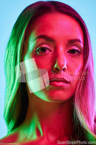 Image of Portrait, skincare or glowing neon lighting on isolated blue background or studio fashion spotlight. Zoom, beauty model or woman face in creative fantasy green, pink or lights art aesthetic in makeup