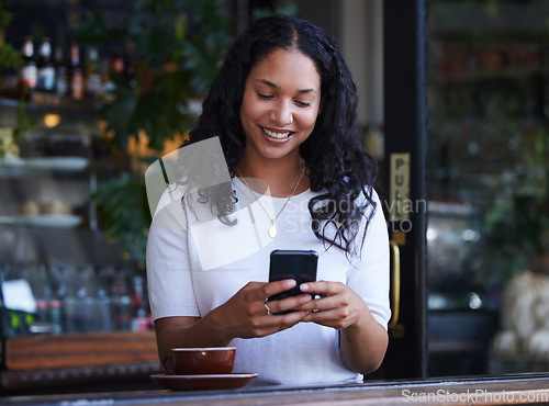 Image of Woman in cafe, smile and smartphone for typing, social media and connection with online banking, relax and break. Female, customer and lady with cellphone, communication and in coffee shop for lunch