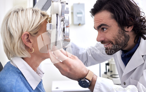 Image of Doctor with woman in a vision test or eye exam for eyesight by doctor, optometrist or ophthalmologist with medical aid. Mature patient or client with a helpful optician to see or check glaucoma