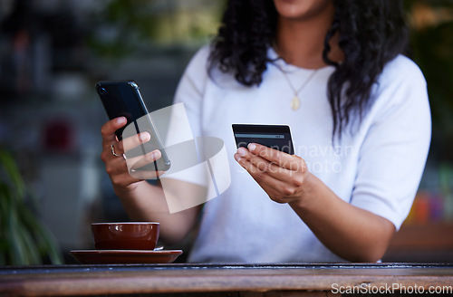 Image of Woman, hands and phone with credit card for ecommerce, online shopping or purchase at coffee shop. Hand of female customer on smartphone for internet banking, app or wireless transaction at cafe