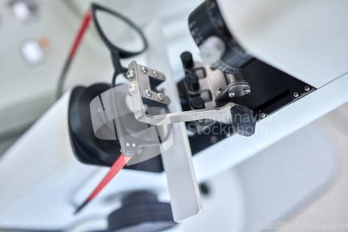 Image of Optometry, vision and a lens meter in a clinic to measure or adjust the level of eyesight improvement from above. Glasses, eyewear and machine for prescription frame spectacles in a medical office