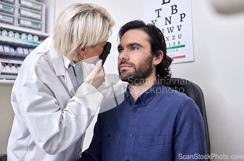 Image of Doctor with a man in a vision test or eye exam for eyesight by doctor, optometrist or ophthalmologist with medical aid. Patient or client with a helpful senior optician to see or check glaucoma