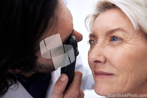 Image of Light, eye check and woman with an optician for healthcare, consultation and vision exam. Lens test, health and senior patient with a male ophthalmologist with a tool to look at visual problem