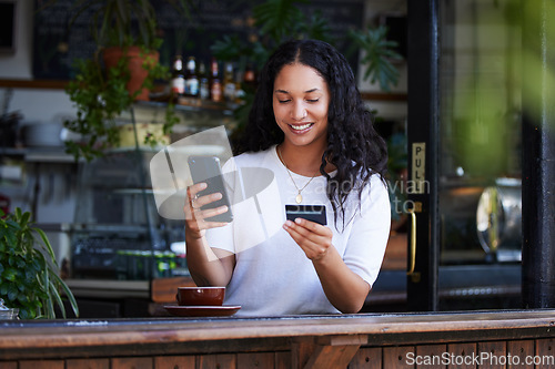 Image of Woman, phone and credit card with smile for ecommerce, online shopping or purchase at coffee shop. Happy female customer on smartphone for internet banking, app or wireless transaction at cafe