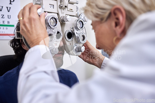 Image of Doctor with customer in vision test or eye exam for eyesight by doctor, optometrist or ophthalmologist. Senior optician helping check retina health of a man, patient or client with medical insurance