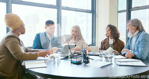 Image of Business people, tablet and teamwork for planning, strategy and ideas by desk in modern office for goal. Corporate group, digital tech and finance team for brainstorming, vision or target in New York