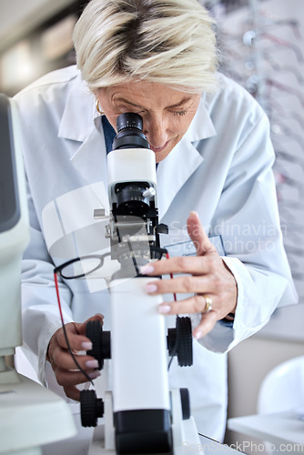 Image of ophthalmology, microscope and glasses with a woman doctor with tools to check lens for eye care. Medical person at work for science, vision and health insurance while working in lab, store or clinic