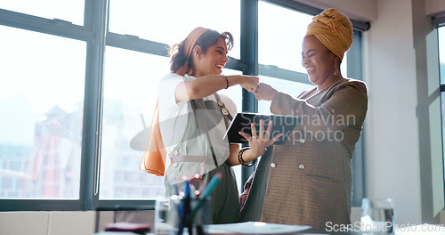 Image of Digital tablet, women and marketing team doing creative research for a project in their office. Collaboration, teamwork and female business partners checking their company website on a mobile device.