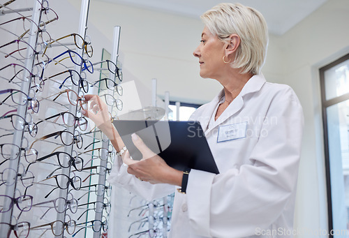 Image of Glasses, optometrist and search with woman and tablet for retail, healthcare or consulting. Shopping, ophthalmology or technology with senior optician in frame store for medical, design or eye care