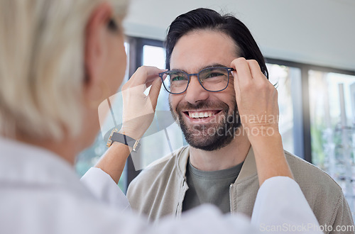 Image of Optometrist, glasses and man with smile in store for vision, eyesight and optical frames. Happy customer face, spectacles and prescription lenses for eye care test, consulting or retail shop services