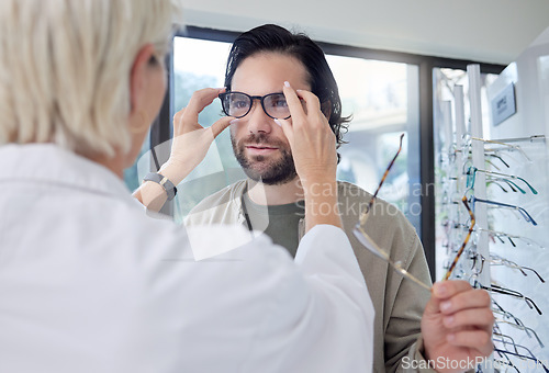 Image of Optometrist, glasses and man in store for choice of frames, eyesight and vision. Customer face, new spectacles and eye care test for prescription assessment, clinic consulting or retail shop services