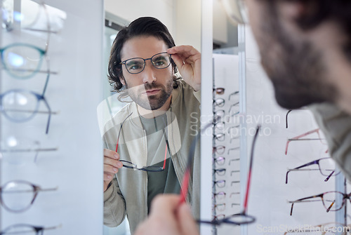 Image of Glasses choice, optometry and man in mirror, vision check and eye care for customer experience of store lens frame. Young client or person eyes healthcare, retail and shop test for optical wellness