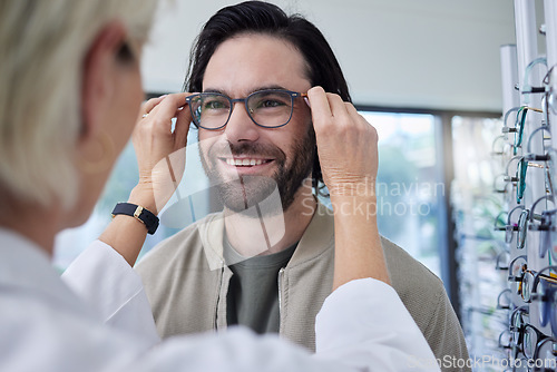 Image of Optician, glasses and happy man in store for vision, eyesight and choice of frames. Customer face, optometrist and lenses for eye care test, healthcare consulting or retail shop services for wellness