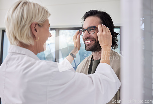 Image of Optician, glasses and man in store for vision, eyesight and optical frames. Happy customer face, optometrist and lenses for eye care test, healthcare consulting and retail shop services for wellness