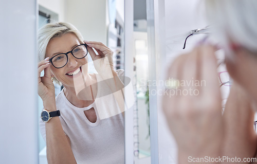 Image of Happy woman customer, glasses and mirror while shopping for lens or frame for eye care vision and wellness. Senior person with smile for making choice or decision for retail sale at optometry store