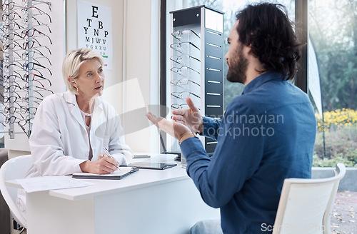 Image of Eye doctor, help or man consulting for eyesight advice at optometrist or ophthalmologist with medical aid. Customer talking or asking questions to check vision health with a trusted senior optician