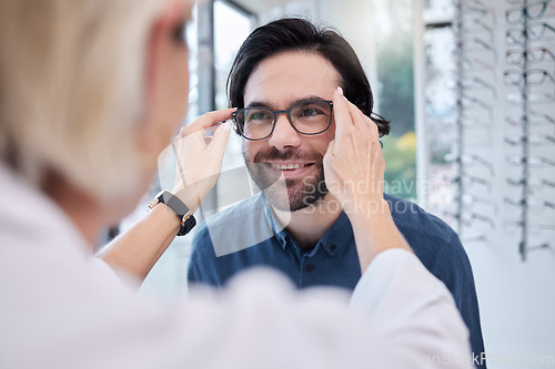 Image of Optician, glasses and face of man in store for vision, eyesight and choice of frames. Optometrist help happy customer with lenses, eye care test and healthcare consulting for retail shop services